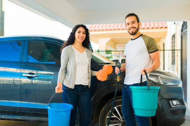 istock Young couple getting ready to wash the car 1451624161