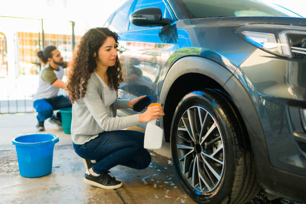 istock Couple cleaning the car tires 1451624187