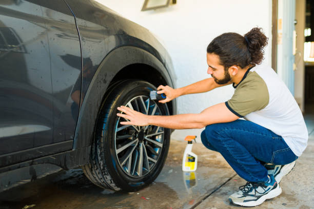istock Mexican man cleaning the car tires 1451624424