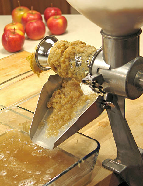 Making applesauce with crank-driven strainer stock photo