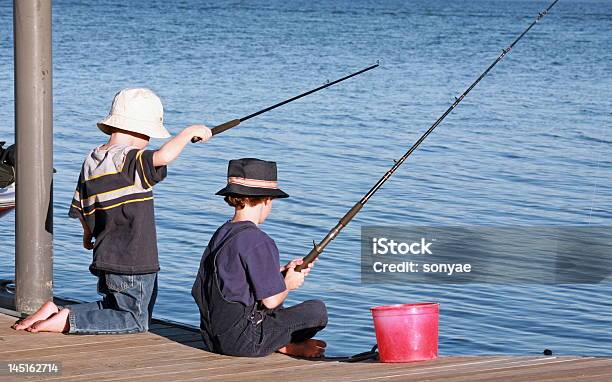 Boys Fishing Off Pier Stock Photo - Download Image Now - Boys, Fishing, Activity