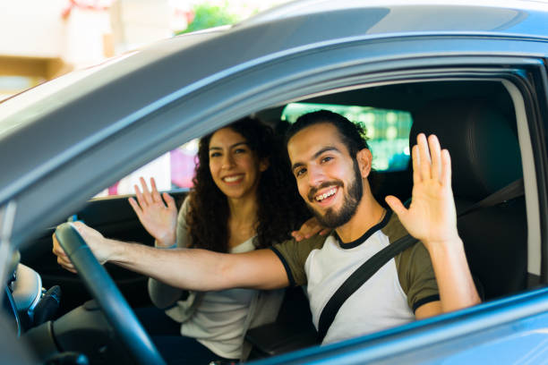 istock Attractive cheerful waving goodbye in the car 1451627387