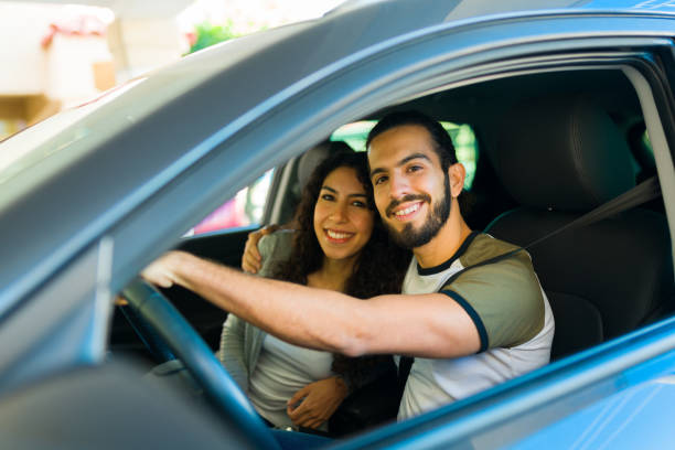 istock Attractive couple embracing while driving 1451627460