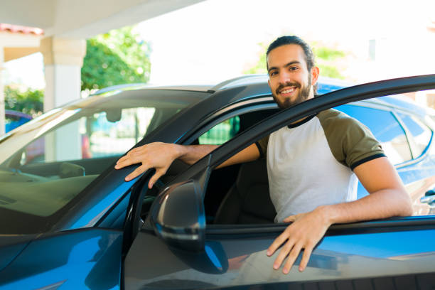 istock Handsome man going on a trip in his car 1451627547