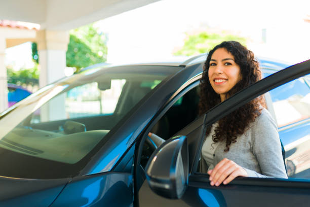 istock Smiling woman ready for a trip in her car 1451627601
