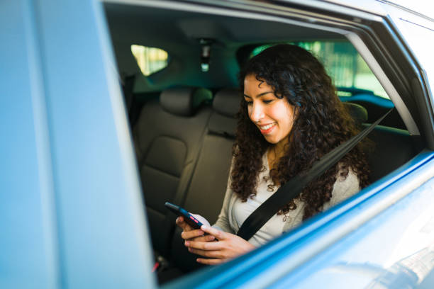 istock Smiling woman passenger using the rideshare app 1451627879