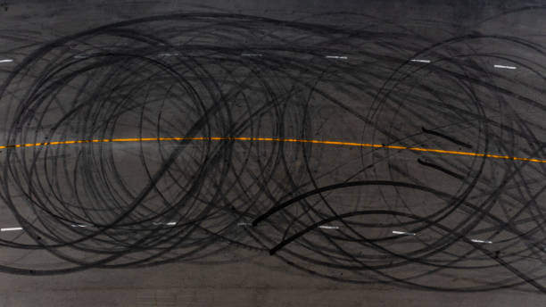 istock Top view tire tracks texture and background, Asphalt texture with line and tire marks, Automobile automotive tire skid mark on race track, Abstract texture car drift tire skid mark. 1451629277