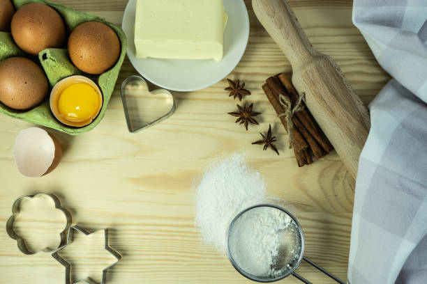 istock Making Christmas cookies on rustic wooden table. Ingredients for baking a cake cookies or sweet pastry on  wooden table background. cookie cutters, ingredients for christmas cookies. Selective focus. 1451629945
