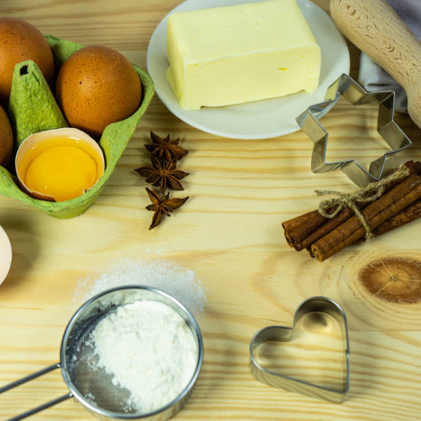 istock Making Christmas cookies on rustic wooden table. Ingredients for baking a cake cookies or sweet pastry on  wooden table background. cookie cutters, ingredients for christmas cookies. Selective focus. 1451629946