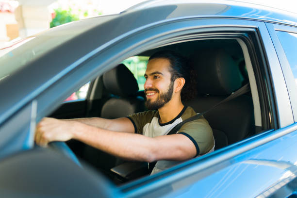 istock Happy man smiling traveling in the car 1451630902
