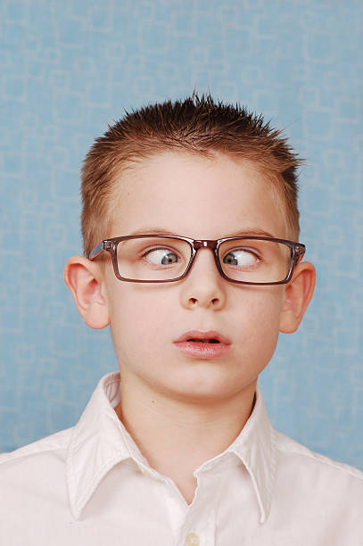 путать genius - child cross eyed nerd eyewear стоковые фото и изображения