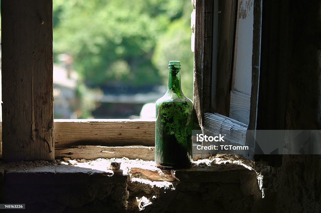 Viejo verde botella de vino en la ventana - Foto de stock de Anticuado libre de derechos