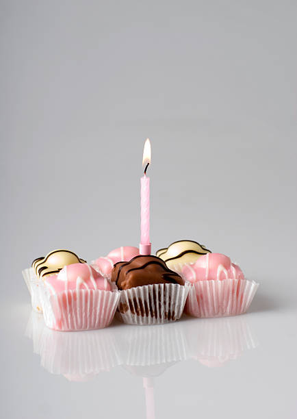 Cup cakes with a candle stock photo