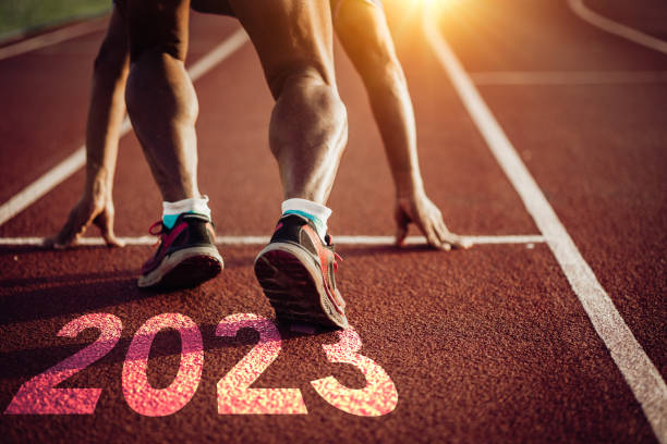 2023, Starting Line, Beginnings, Aspirations, Running Man preparing to run for the new year 2023 forward athlete stock pictures, royalty-free photos & images