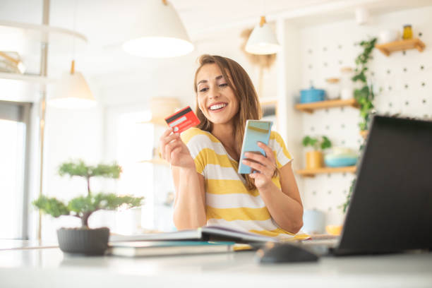 istock Cheerful  woman doing online shopping 1451639161