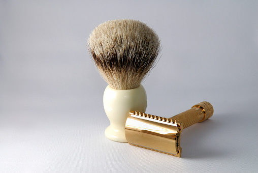 Gold old fashioned double edge razor with shaving badger brush