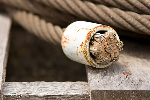 High Tensile Steel Wire Seven Cable with Rusty Anchor End placed on timber crate. Grey, white, and Brown
