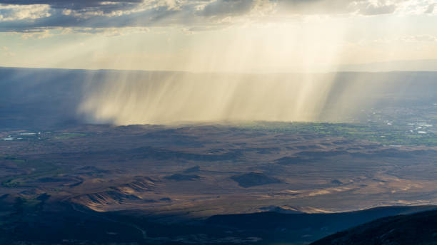 istock Rain falling over valley in the distance 1451647316