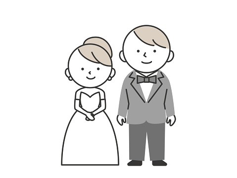 Bride and groom at wedding. Groom in tuxedo and bride in wedding dress standing side by side.
