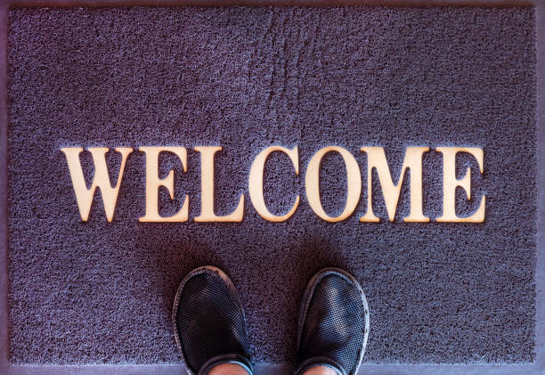 istock Top view of foot on welcome mat 1451665230