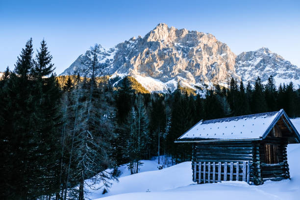 Small wooden hut in wintry Zugspitze landscape stock photo