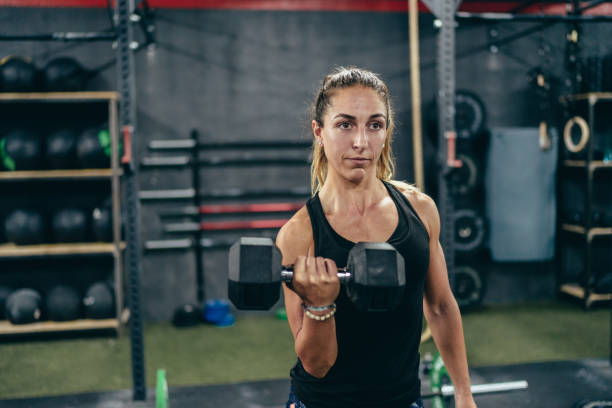 istock A blonde woman exercising with a dumbbell 1451671655