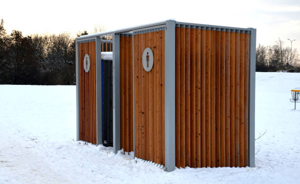 istock closing cage for placing chemical toilets. unsightly plastic boxes are inside a metal house with a flat roof and wooden slats on the walls. athletes in park or mothers with children can pee, wash hand 1451676984