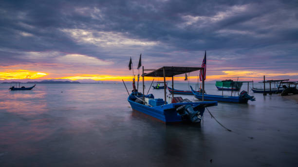 istock Small fishing boat by the beach 1451678444