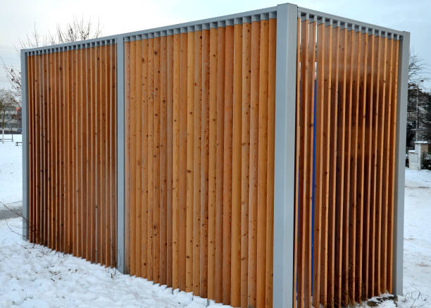 istock closing cage for placing chemical toilets. unsightly plastic boxes are inside a metal house with a flat roof and wooden slats on the walls. athletes in park or mothers with children can pee, wash hand 1451678486