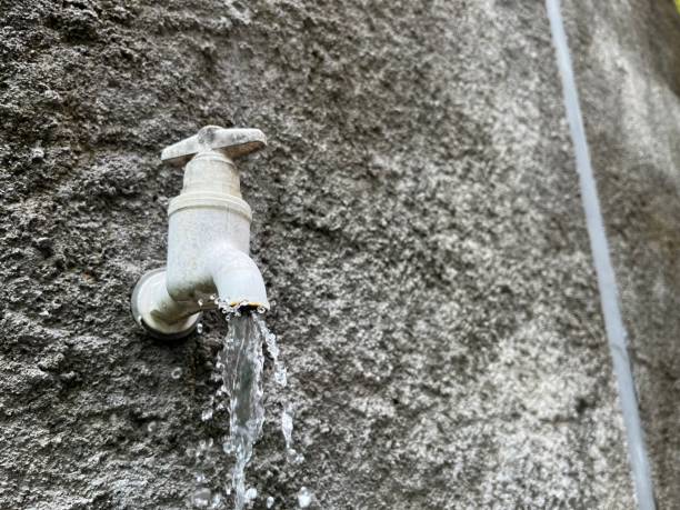 istock Old plastic water tap on concrete wall 1451679002