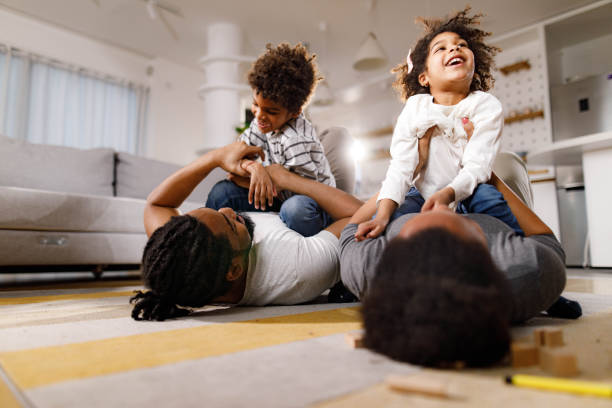 istock Playful black family having fun on floor at home. 1451679980