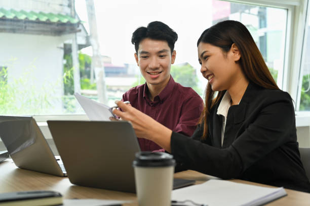 istock Smiling businesswoman explaining new project and discussing corporate business plan with her coworker. 1451683507