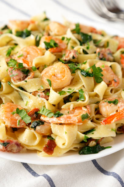 istock Homemade Shrimp Spinach Bacon Alfredo on a Plate, side view. Close-up. 1451689142