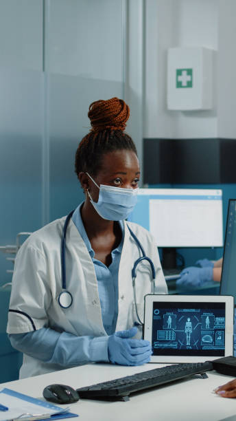 istock Doctor holding tablet with human body analysis for checkup visit 1451692177