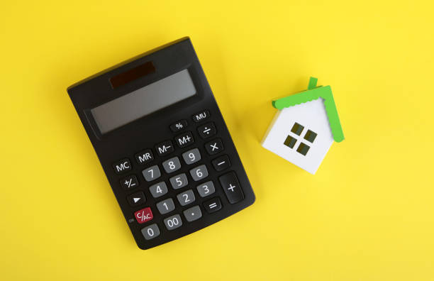 istock Miniature house and  calculator,Home finance concept 1451693844
