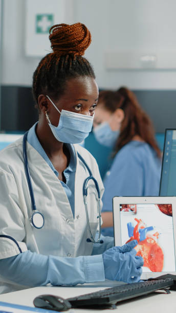 istock Doctor pointing at tablet with heart organ on screen 1451694477