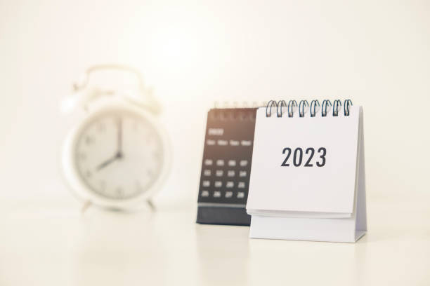 istock 2023 business calendar and alarm clock on office table in new year day. Make a work plan for the start of the year. Concept about Celebration, Business, Christmas, New Year. 1451694630