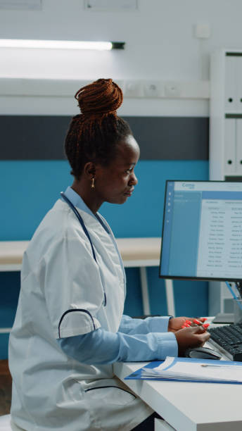 istock Patient explaining pain and symptoms to doctor at appointment 1451695377