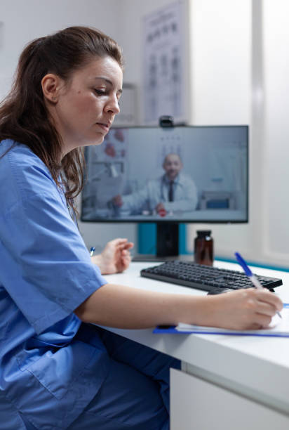 istock Therapist nurse discussing sickness diagnostic with remote doctor 1451695692