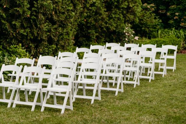 istock Rows of chairs on the lawn outside for a wedding ceremony 1451696381