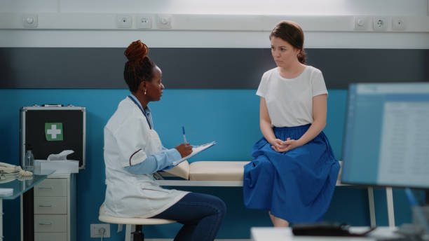 istock Doctor consulting patient and taking notes for diagnosis 1451696679
