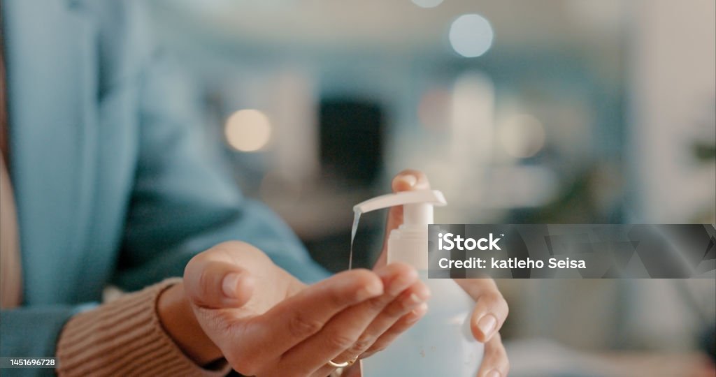 Hands, sanitizer and woman for covid management, risk and safety in office on blurred background. Hand, cleaning and working girl with antibacterial for work compliance, germ and bacteria protection Corporate Business Stock Photo