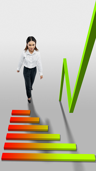 Asian businesswomen walking to increasing graph with colored background