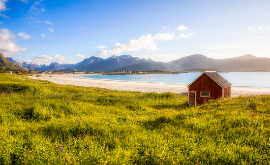 Afternoon shot of the worn hut on beautiful Ramberg Beach, Flakstad Island, Lofoten, Norway