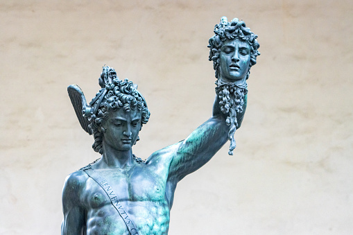 Perseus with the Head of Medusa by Benvenuto Cellini at Loggia dei Lanzi on Piazza della Signoria. This sculpture which is in a public space on a town square was built between 1545-1554.