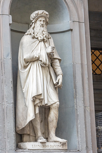 Sculpture of Leonardo da Vinci (1452-1519) by Luigi Pampaloni from the 19th century in the open public space called the Niches of the Uffizi Colonnade in Florence, Italy