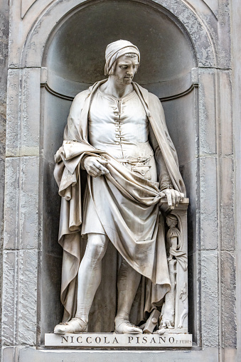 Nicola Pisano (c1220-1284) in the open public spaces of the Niches of the Uffizi Colonnade in Florence, Italy. He was an Italian sculptor who specialised in the classical Roman style. He was the father of Giovanni Pisano. His sculpture was designed by Pio Fedi (1815-1892).