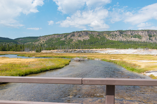 Firehole River from a bridge at the path through the area of the Upper Geyser Basin. Yellowstone National Park, Wyoming, USA.