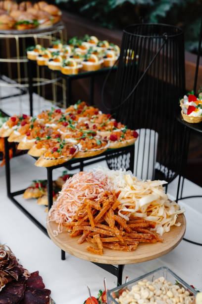 Buffet table of reception with cold snacks, meat and salads