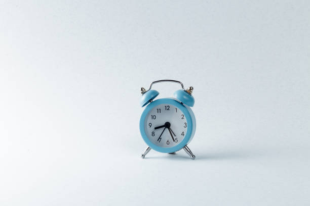 istock blue clock stands on a gray cement background. trendy concrete background. time 8:27 am 1451727721